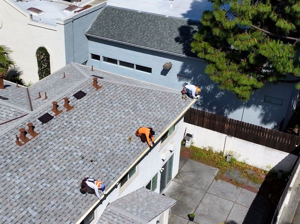a team working on gutters on a house